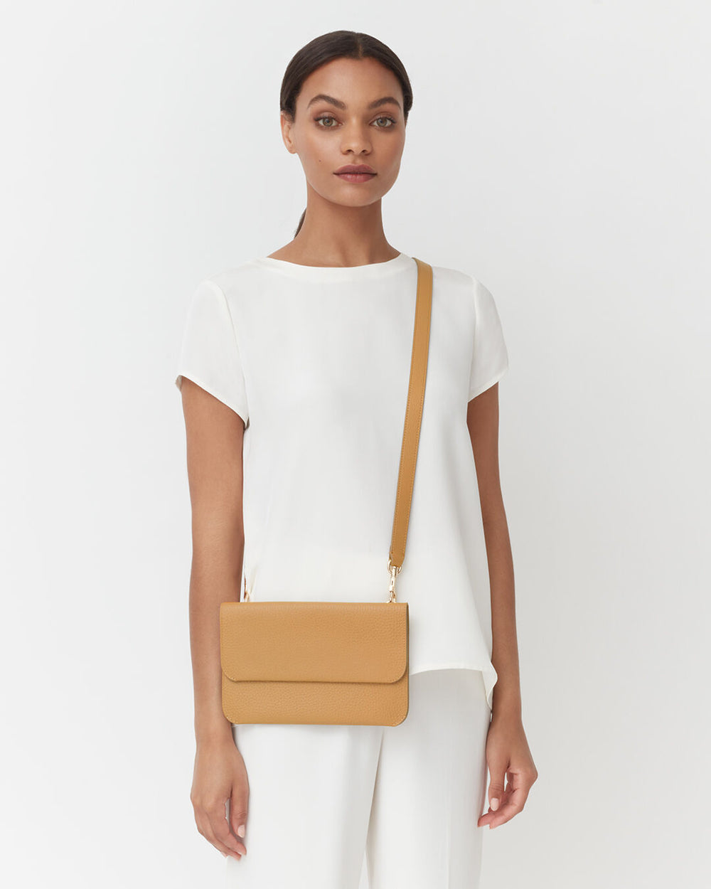 System Flap Bag Woman standing with a shoulder bag