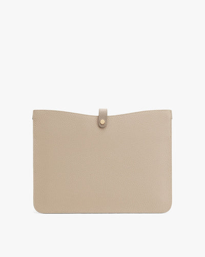 Textured clutch bag with a flap closure