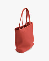Vertical tote bag with two handles, standing upright.