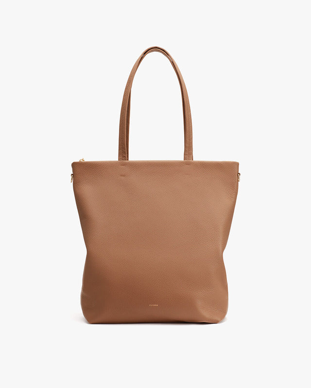 Leather tote bag with two handles and a zipper.