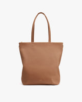 Leather tote bag with two handles and a zipper.