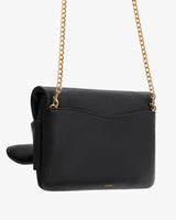 Handbag with a chain strap and front flap closure, isolated on a white background.