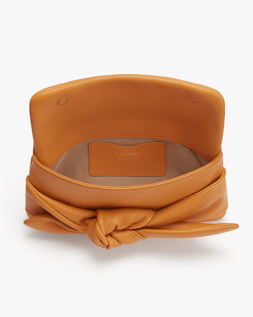 Bow Clutch Purse with a knotted design on the front and a brand label inside.