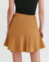 Person from the back wearing a skirt and top.