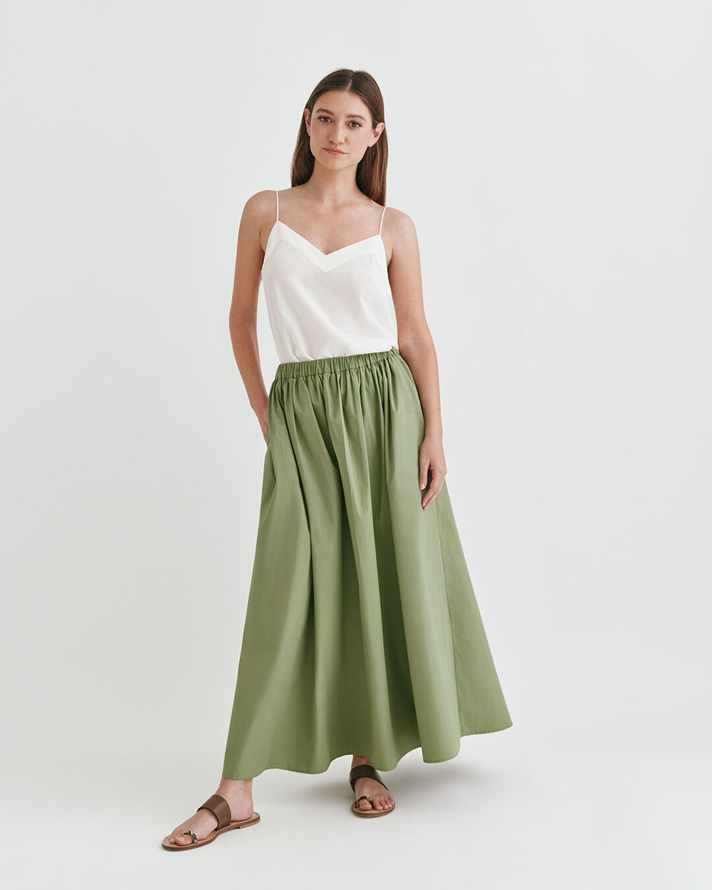 Poplin Gathered Skirt Woman in a sleeveless top and long skirt standing in a studio.