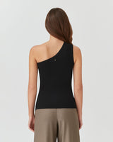 Woman wearing a sleeveless top and pants, standing with her back to the camera.