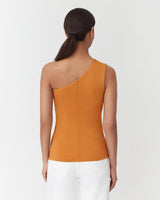 Woman from behind with one shoulder sleeveless top and low bun hairstyle.