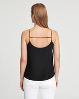 Woman facing away, wearing a sleeveless top with thin straps.