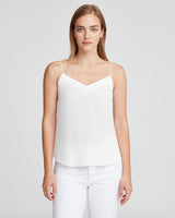Woman standing in a sleeveless top and pants, facing forward
