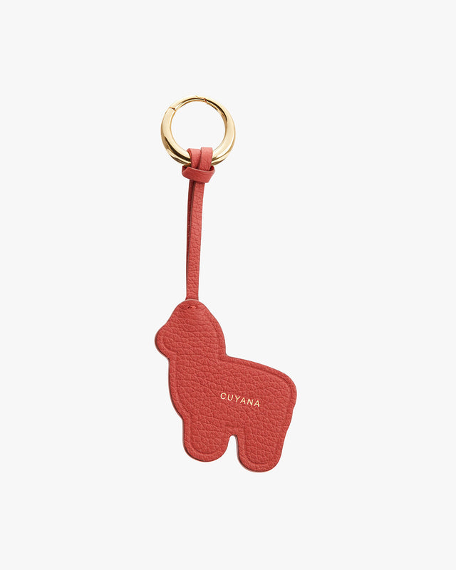 Keychain in the shape of an alpaca with a brand name embossed.