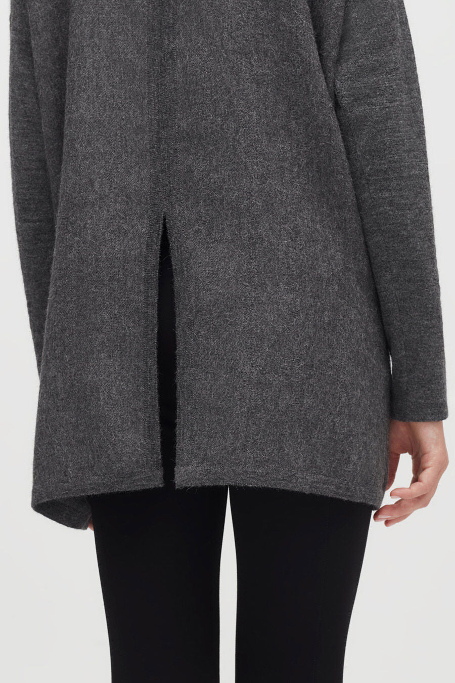 Alpaca Open-Back Turtleneck Sweater Person wearing a coat with a slit at the back.