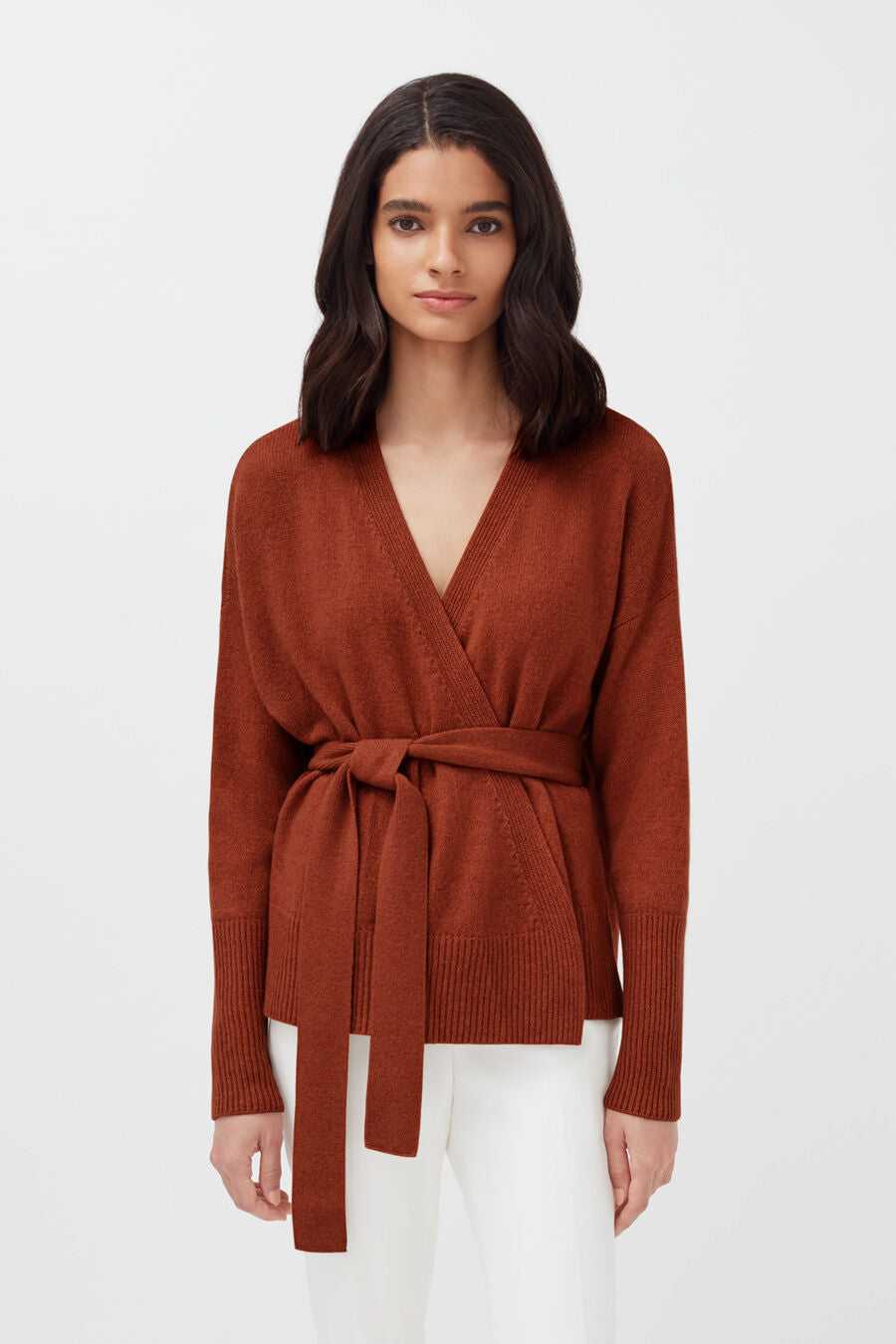 Recycled Cashmere Soft Wrap Sweater Woman in v-neck sweater with waist tie, standing.