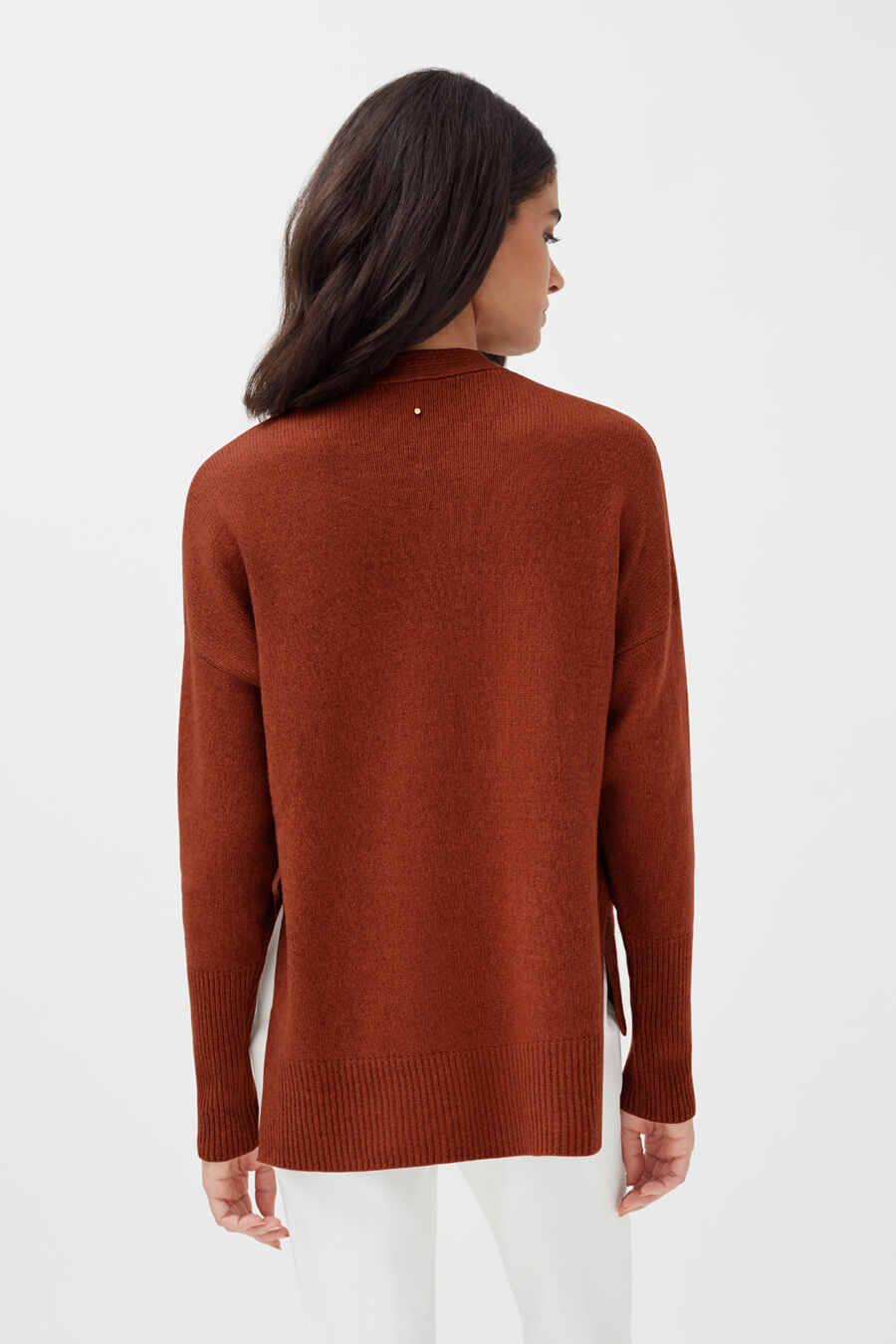 Recycled Cashmere Soft Wrap Sweater Woman in a long sleeve top standing with her back facing the camera.