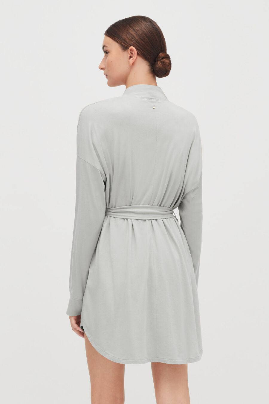 Organic Pima Robe Woman wearing a dress with a tied belt, viewed from the back.