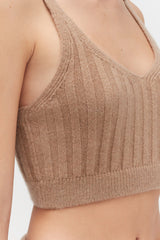 Close-up of a person wearing a sleeveless top.