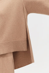 Close-up of a sweater's sleeve and bottom hem.