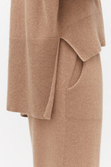 Close-up of a sweater and skirt with pocket detail.