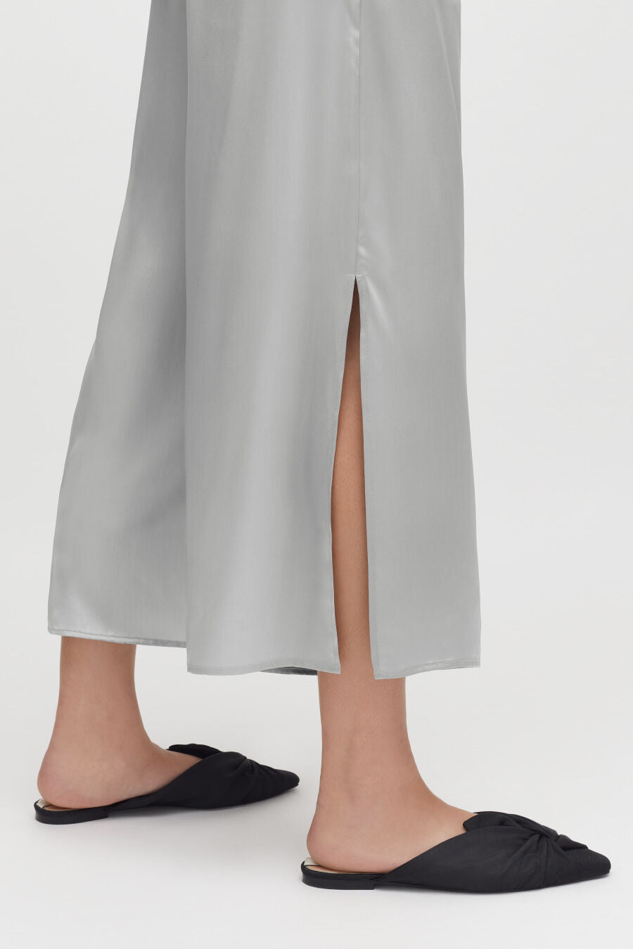 Washable Charmeuse Cropped Wide-Leg Pant Person wearing a long skirt with a front split and flat shoes.
