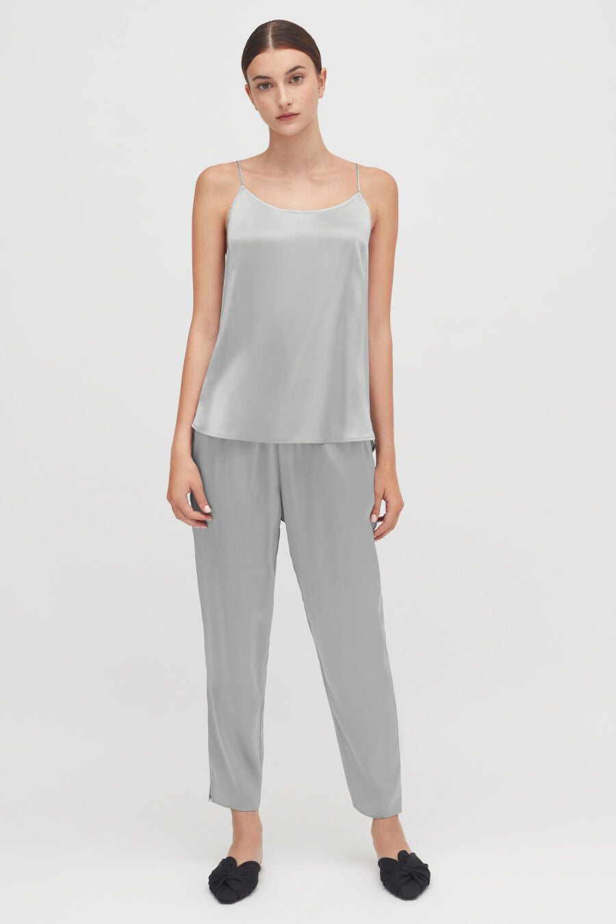 Washable Charmeuse Tapered Pant Woman standing in a casual outfit with slip-on shoes.