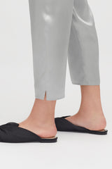 Person standing in slippers, showing only legs and feet.