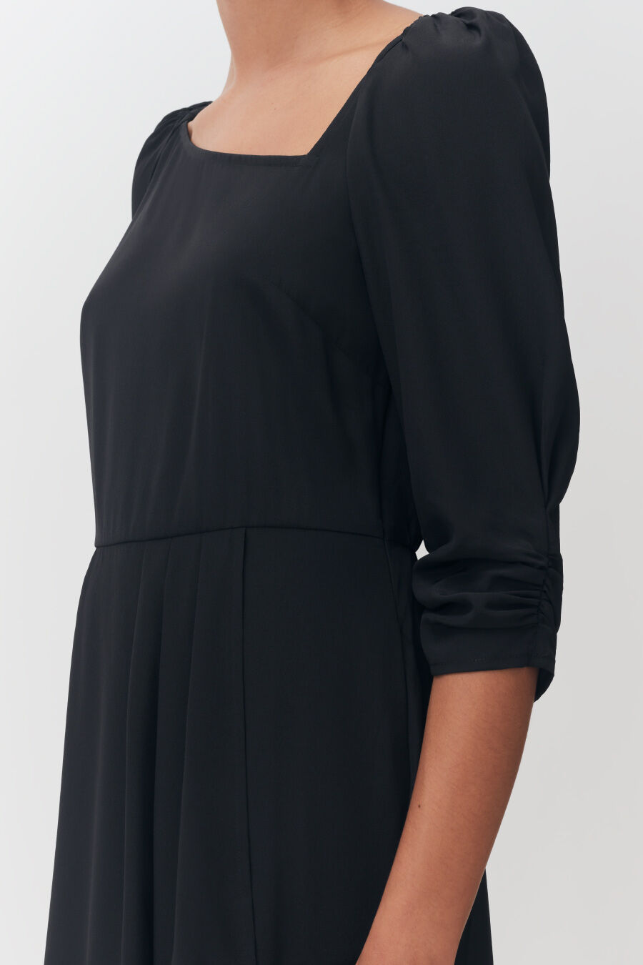 Silk Drape Front Dress Woman wearing a long-sleeved dress, view focused on upper body and arm.