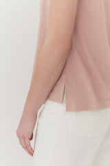 Close-up of a person's arm and torso in a casual outfit.