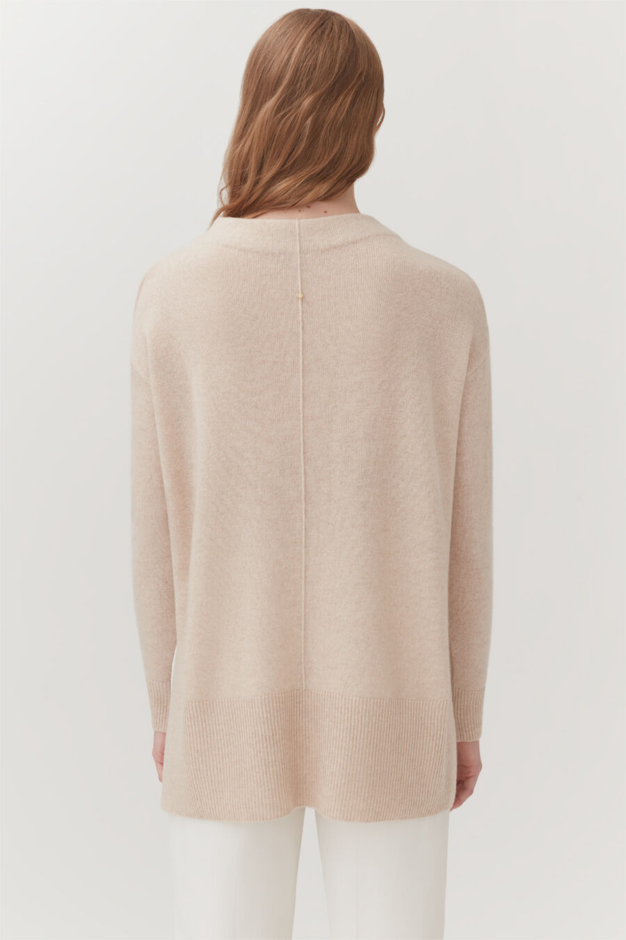 Single-Origin Cashmere Funnel Neck Sweater Person seen from behind wearing a long-sleeved top and pants.