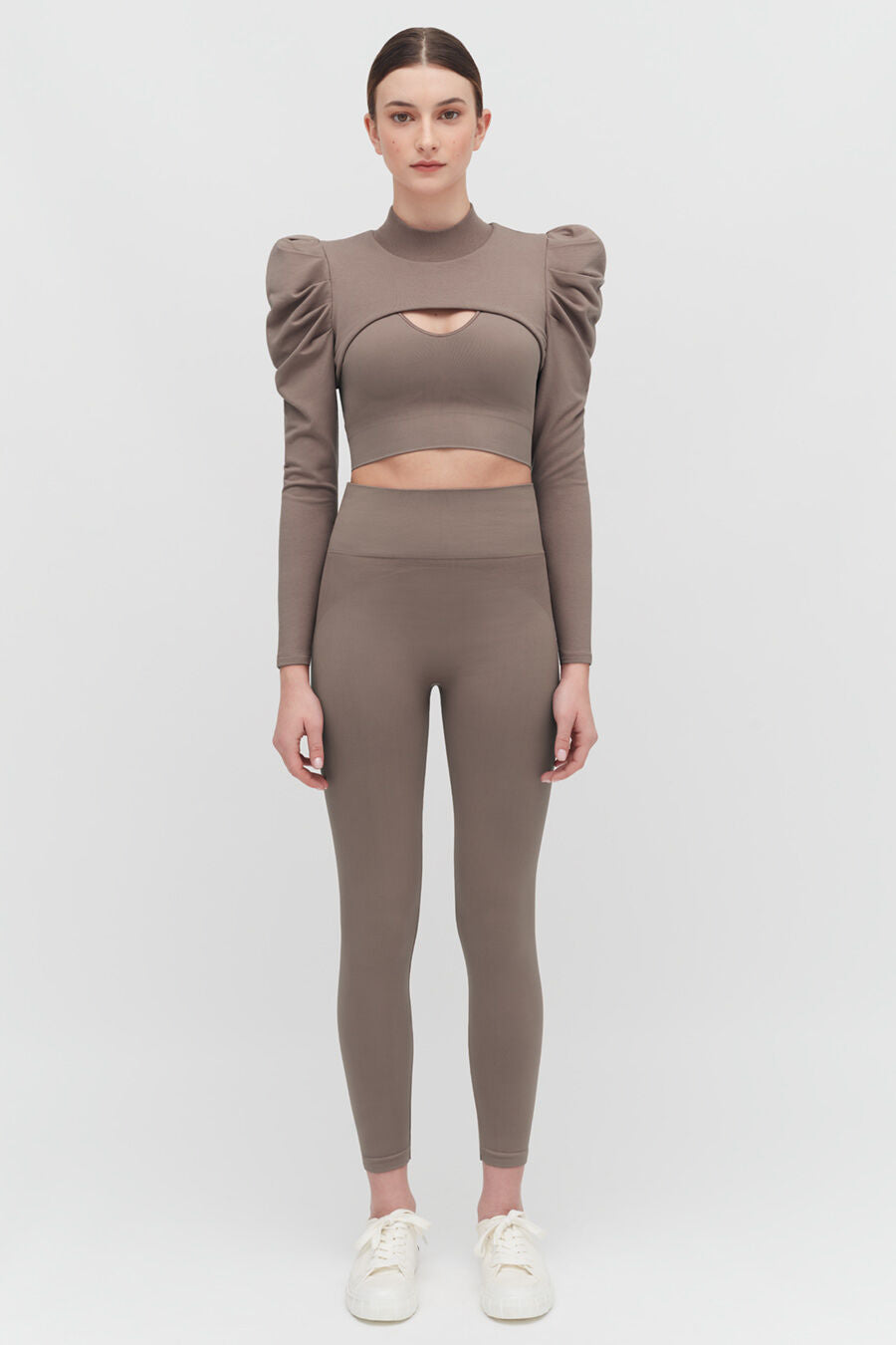 French Terry Puff Sleevelette Woman standing in a long-sleeve crop top and leggings with sneakers.