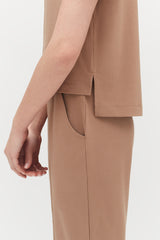 Close-up of a person's side showing the arm and torso with a jacket and pants.