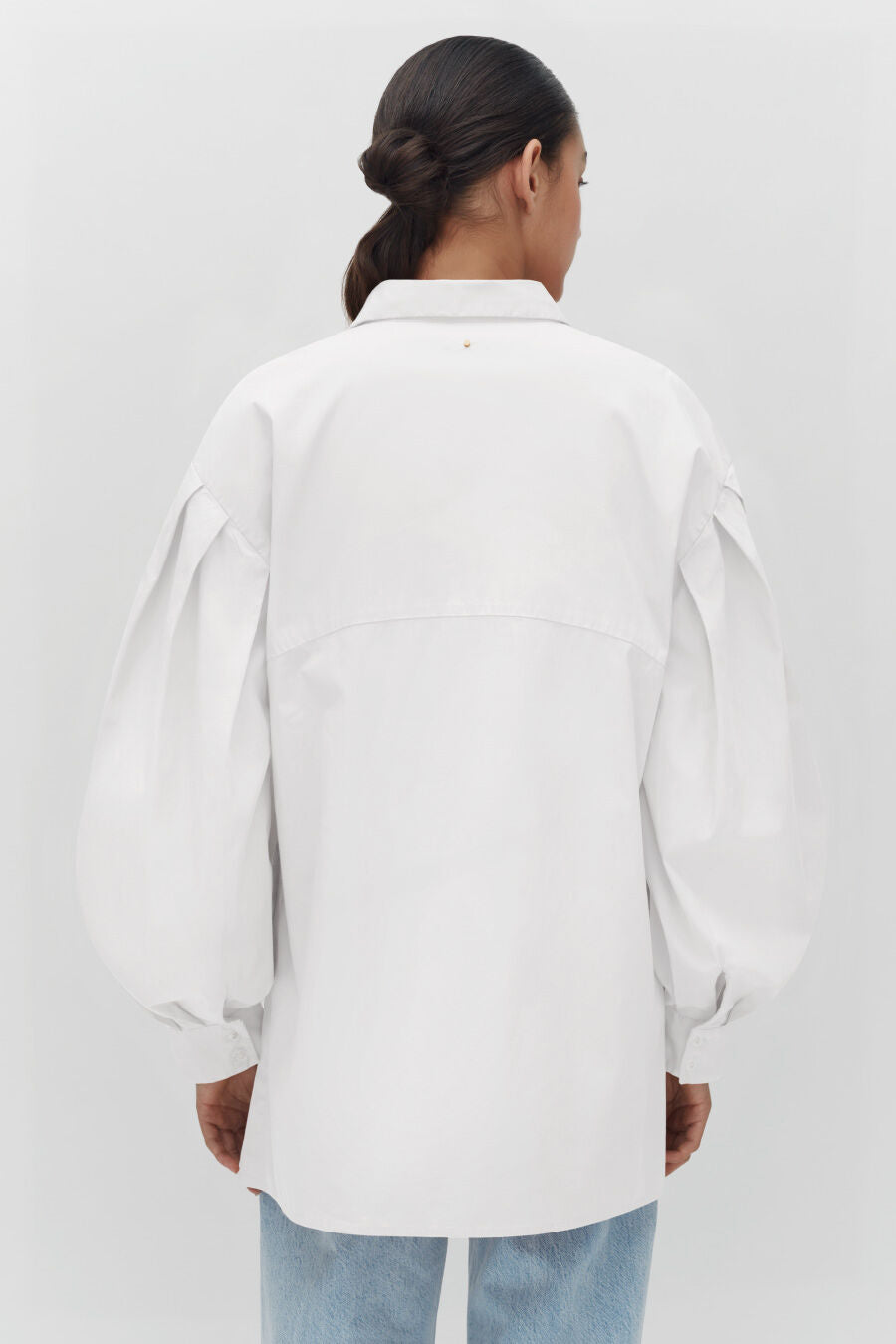 Poplin Balloon Sleeve Shirt Person facing away from camera wearing an oversized shirt and jeans.