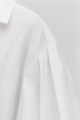 Close-up of a shirt with a collar and a partial sleeve.