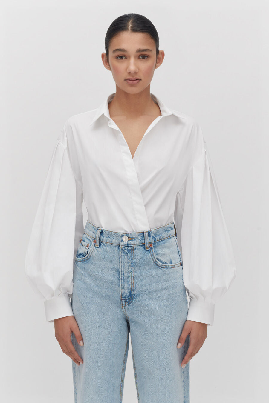 Poplin Balloon Sleeve Shirt Woman in a blouse and jeans standing with hands at her sides.