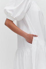 Person placing hand in pocket of a dress