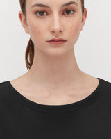 Portrait of a woman looking straight ahead.