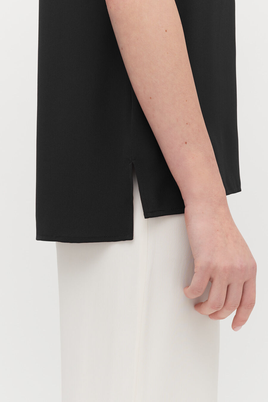Silk High-Low Tee Close-up of a person's arm beside their torso.