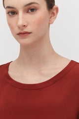 Close-up of a woman with a neutral expression looking at the camera.