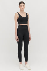 Woman standing in exercise outfit with sneakers