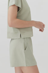 Person standing, partial view focusing on torso and upper legs.