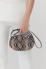 Person holding a patterned handbag