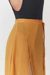 Person wearing a skirt and a fitted top, viewed from the back.