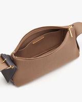 Open shoulder bag with a zipper showing internal pocket.