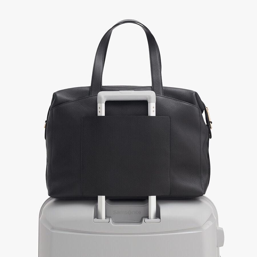 Bag on top of a suitcase, handles up