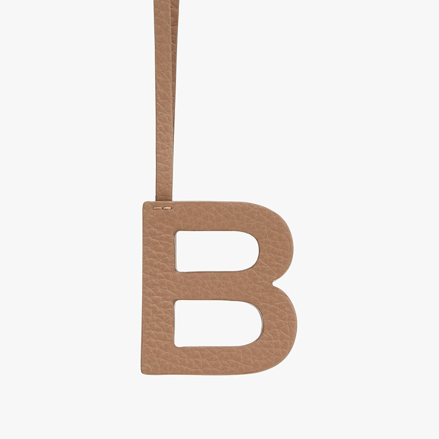 Letter B hanging from a strap.