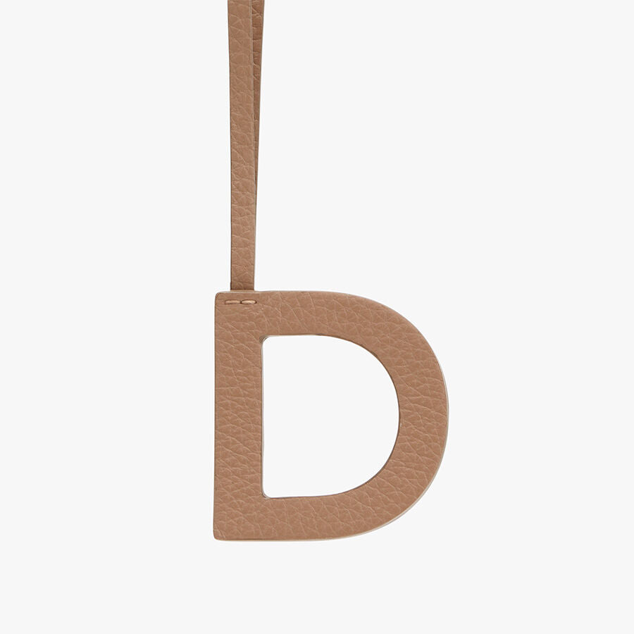 Letter D hanging from a strap