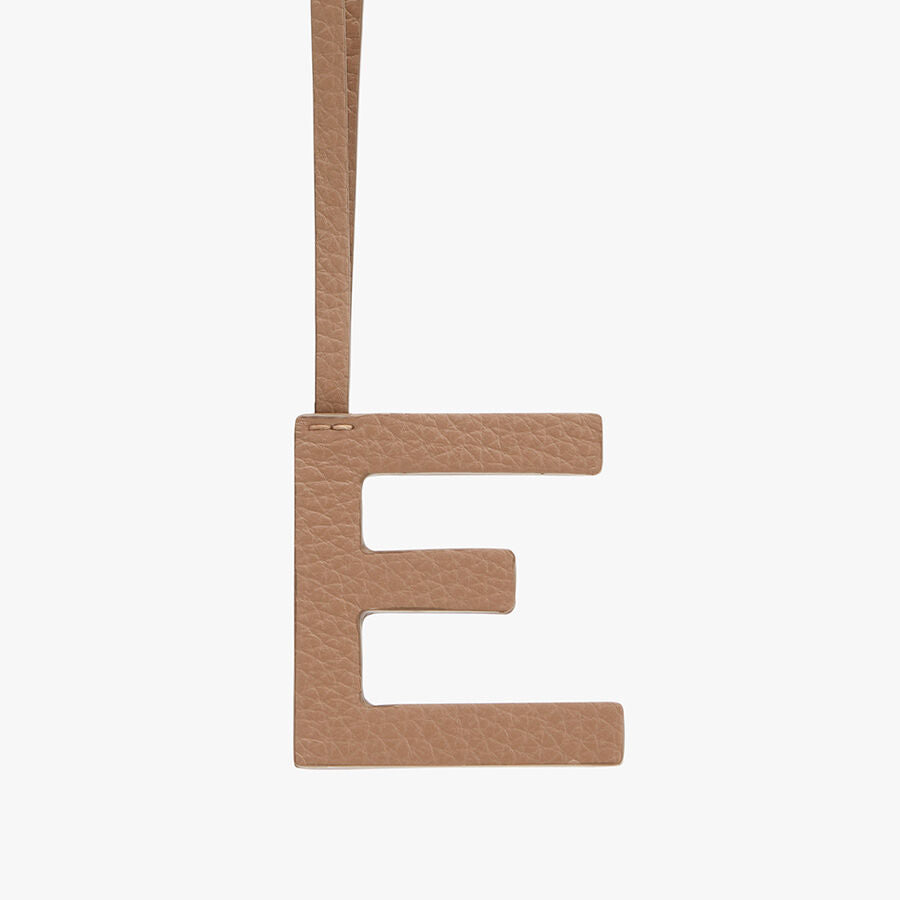 Letter E pendant hanging by a strap