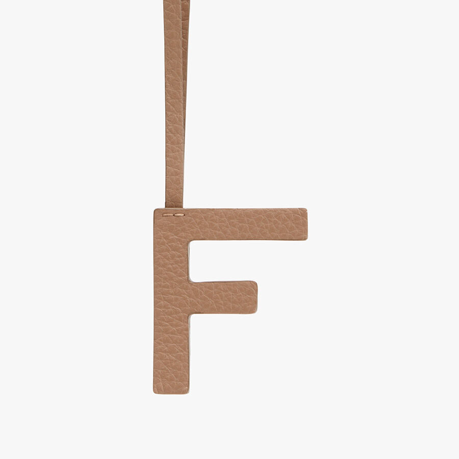 Letter F hanging from a string.