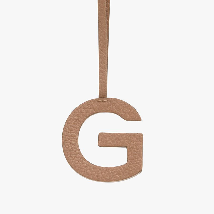 Letter G hanging from a string