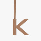 Letter K hanging from a strap.