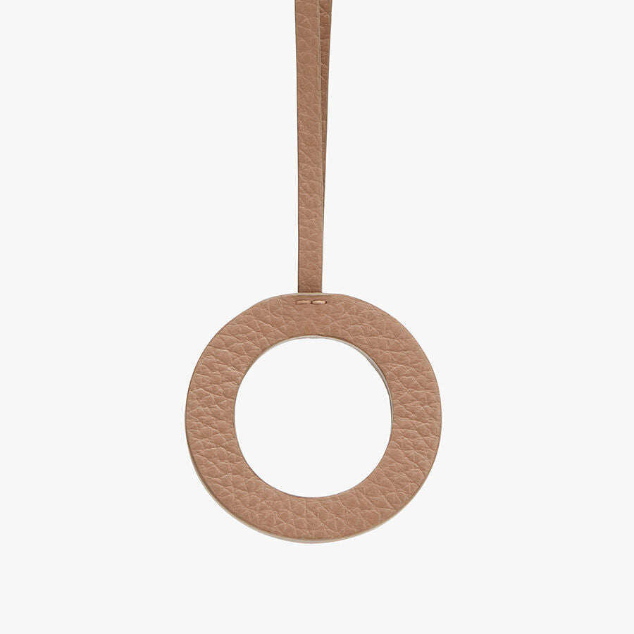 Round object with a looped strap attached at the top.