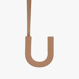 Leather strap shaped like the letter U against a plain background.